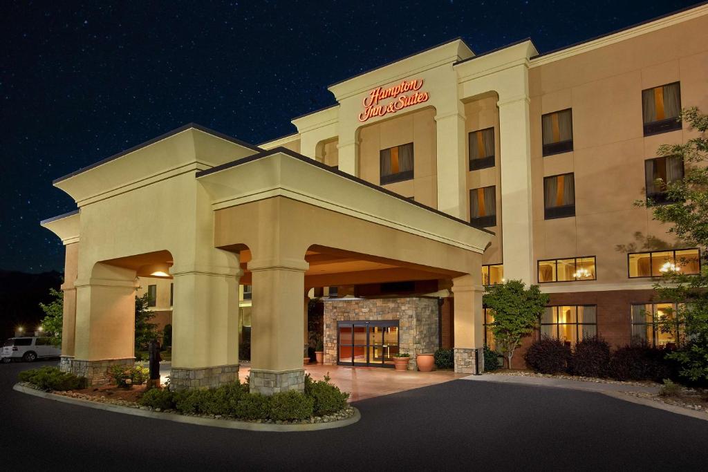 un edificio de hotel con un cartel en él por la noche en Hampton Inn & Suites Sevierville at Stadium Drive, en Kodak