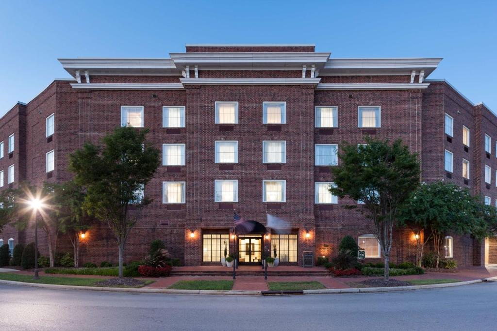 a large red brick building with the front entrance at Homewood Suites by Hilton Huntsville-Village of Providence in Huntsville