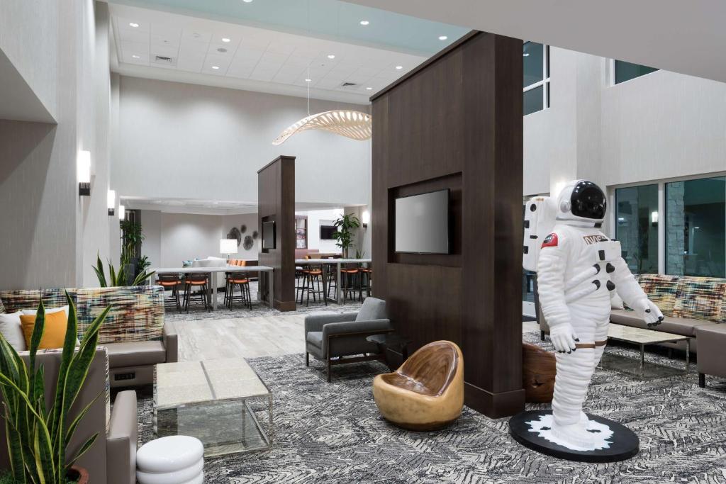 a statue of an astronaut in a hotel lobby at Hampton Inn & Suites Cape Canaveral Cruise Port, Fl in Cape Canaveral