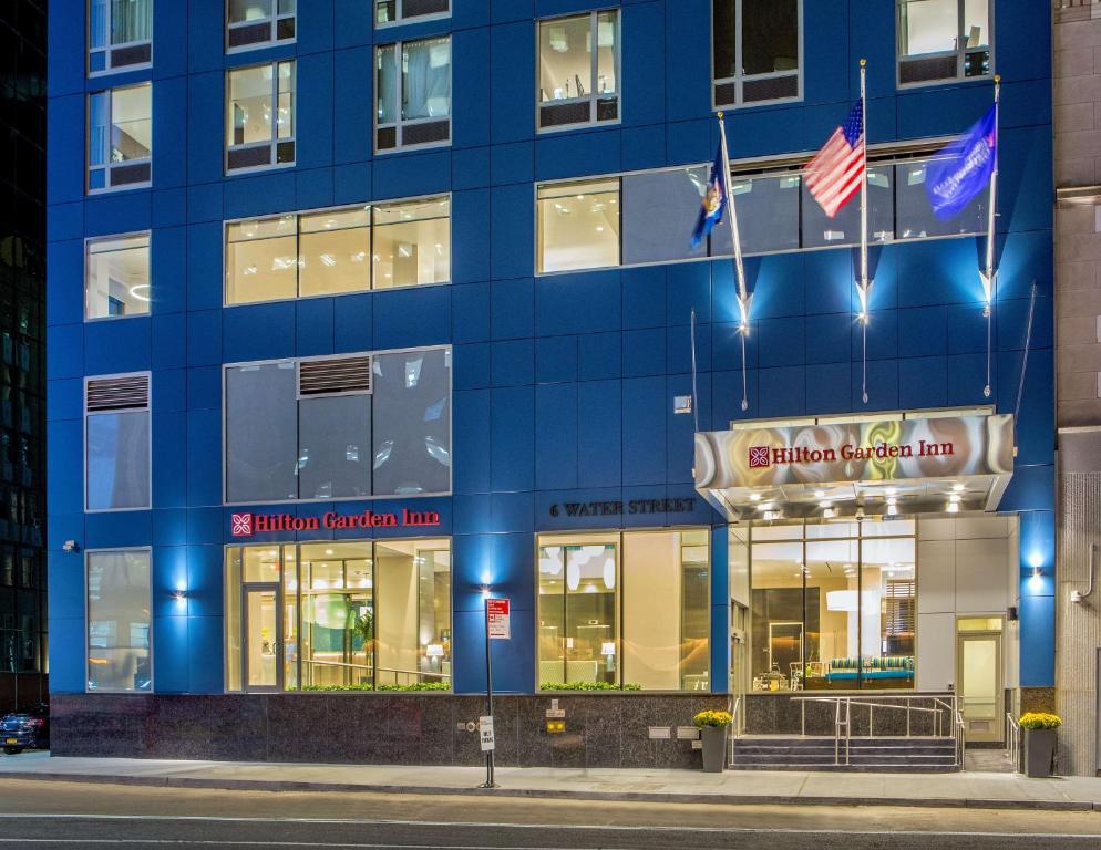 a blue building with flags in front of it at Hilton Garden Inn NYC Financial Center/Manhattan Downtown in New York