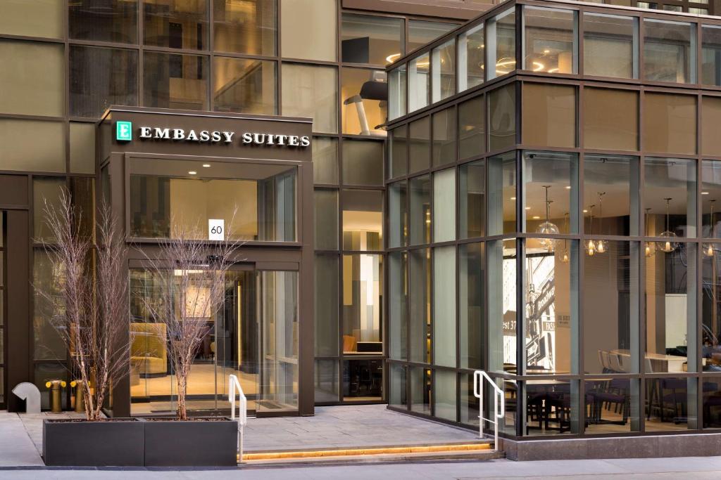 an entrance to an office building with glass windows at Embassy Suites By Hilton New York Manhattan Times Square in New York