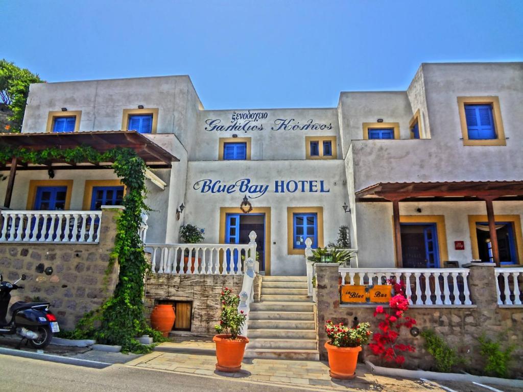 a large building with stairs in front of it at Blue Bay Hotel in Skala