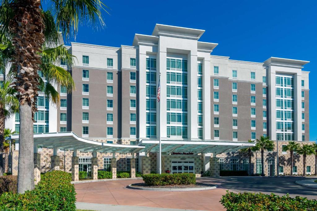 a hotel with a palm tree in front of it at Hampton Inn & Suites Tampa Airport Avion Park Westshore in Tampa