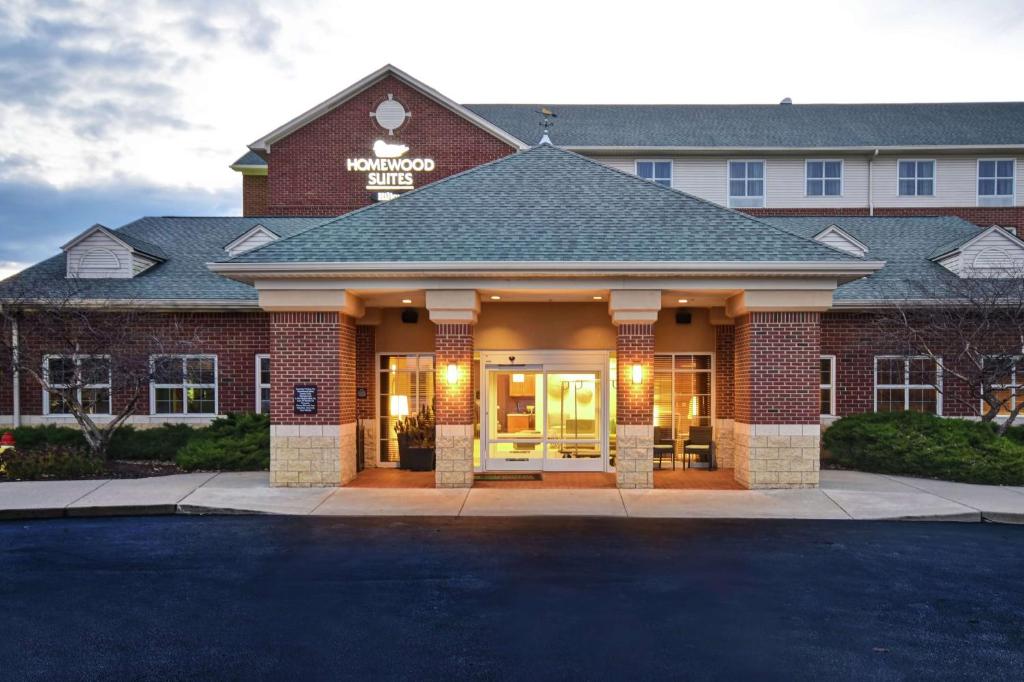 a hotel with a sign on the front of it at Homewood Suites by Hilton Cincinnati-Milford in Milford