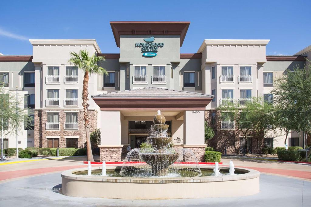 a hotel with a fountain in front of a building at Homewood Suites by Hilton Phoenix-Avondale in Avondale