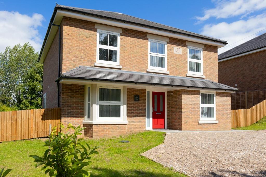 a brick house with a red door at Amazing 5bed, Free Parking Short and long term stays in Burton upon Trent