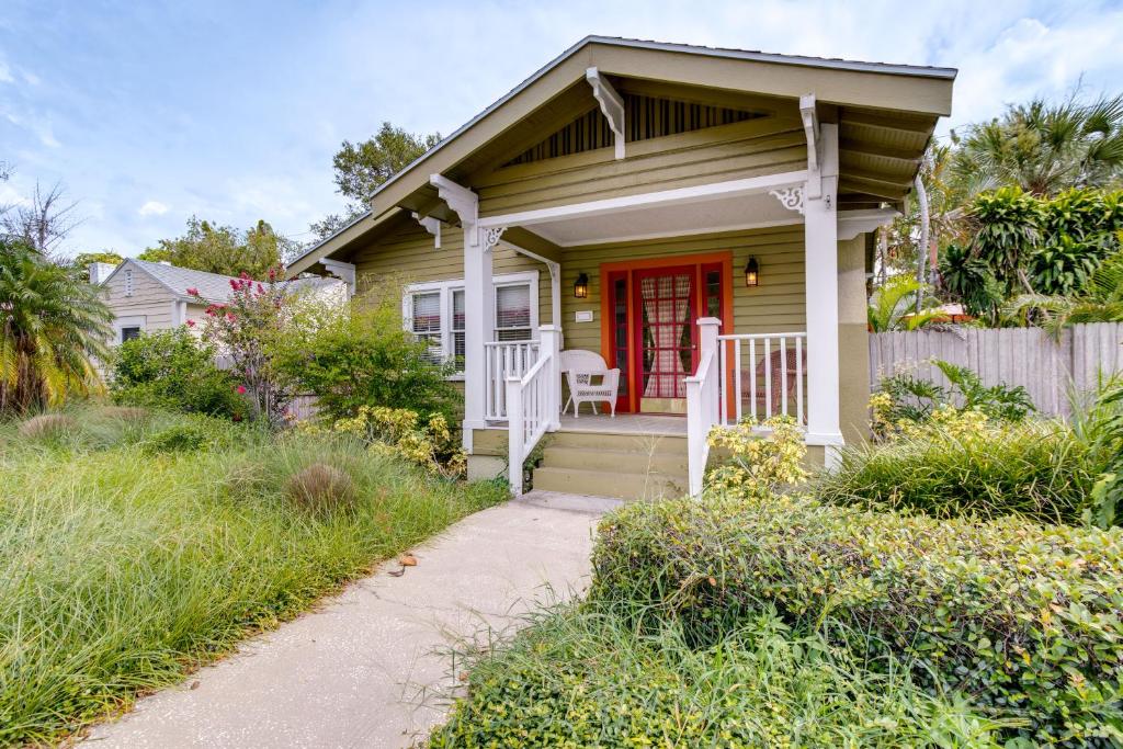 a small house with a red door and a porch at Charming St Petersburg Bungalow 2 Mi to Downtown! in St Petersburg