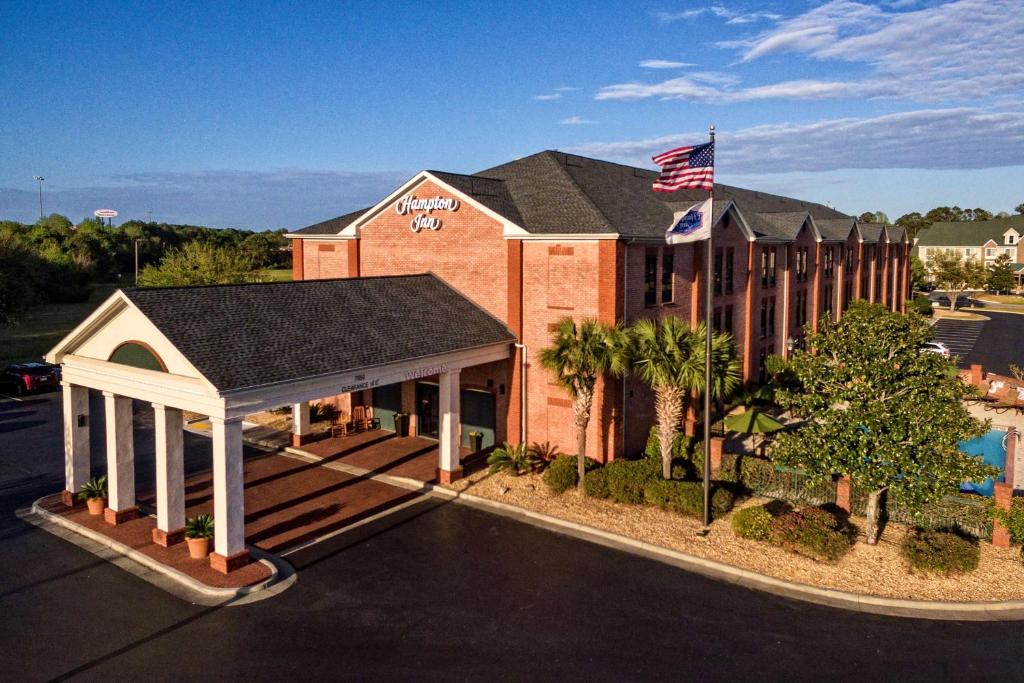 a rendering of a hotel building with an american flag at Hampton Inn Savannah-I-95-North in Port Wentworth