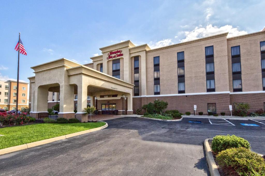un hotel con bandera americana en un estacionamiento en Hampton Inn & Suites Toledo-Perrysburg, en Rossford