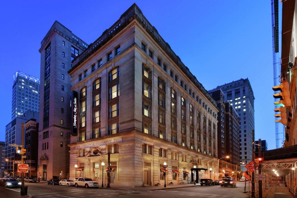 a large building on a city street at night at Hampton Inn & Suites Baltimore Inner Harbor in Baltimore