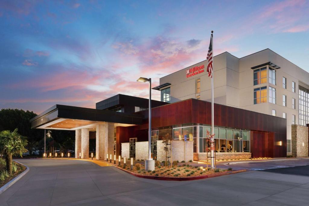 a building with an american flag in front of it at Hilton Garden Inn Sunnyvale in Sunnyvale