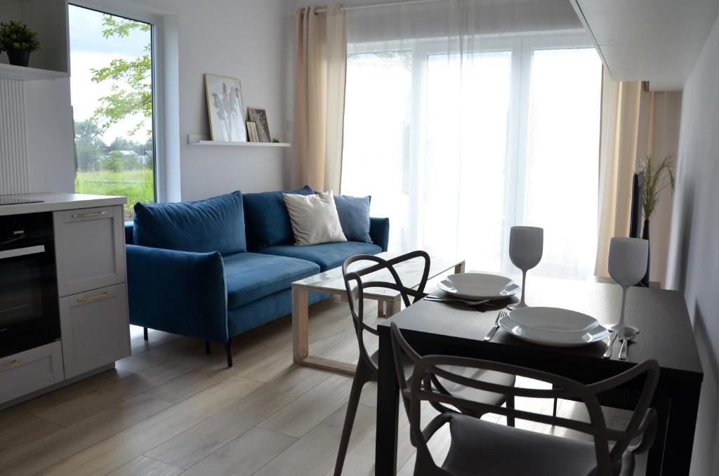 a living room with a blue couch and a table at Morze Wyspa in Gdańsk