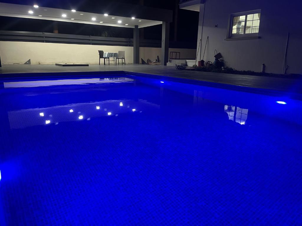a large swimming pool with blue lights in a house at Palm Villa in Kyrenia