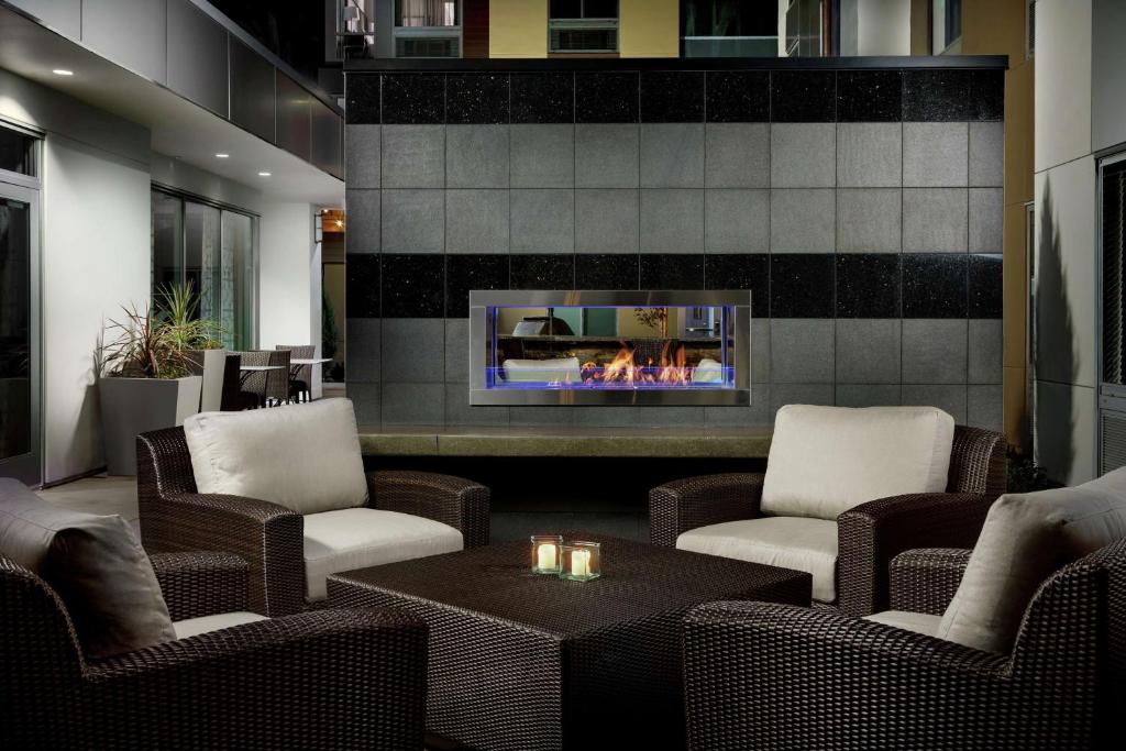 a lobby with chairs and a fireplace and a table at Homewood Suites By Hilton San Jose North in San Jose