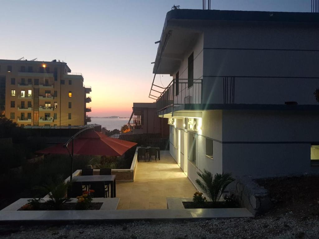 a balcony of a building with a sunset in the background at SOLE INN in Vlorë