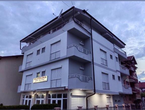 a large white building with a sign on it at Vila Bolonja in Struga