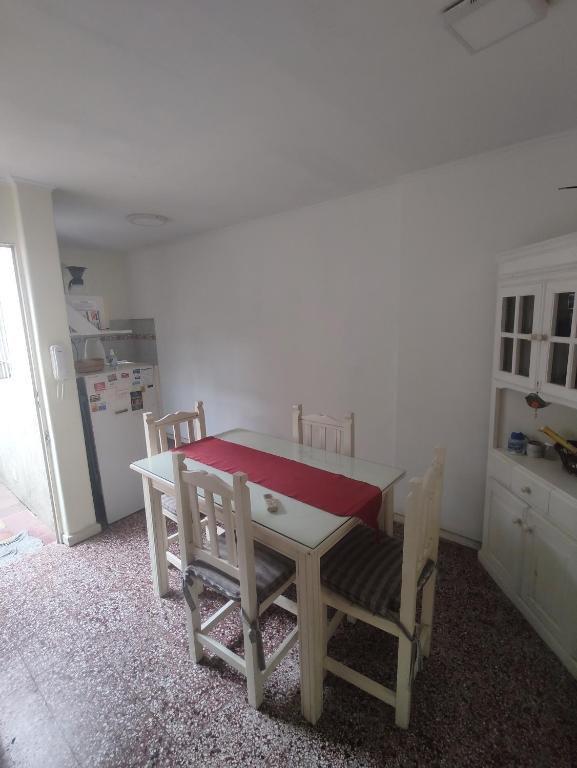 a kitchen with a table and chairs and a refrigerator at Departamento en Tandil in Tandil