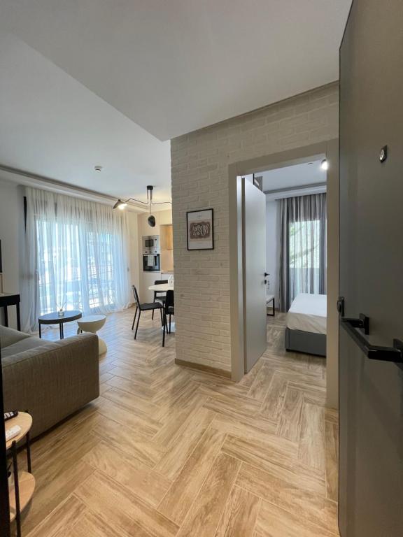 a living room with a couch and a bedroom at C&C3 Apartments in Alexandroupoli
