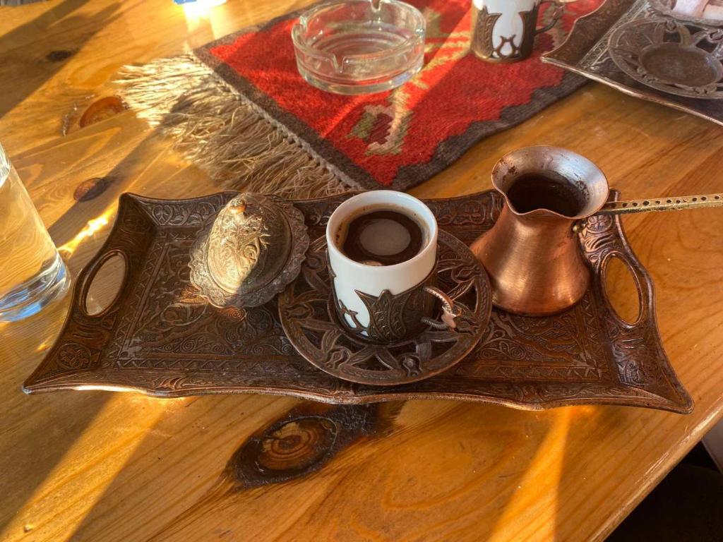 a tray with a cup of coffee on a table at Modern&Cozy Bosnian house with GARDEN+FREE parking in Sarajevo