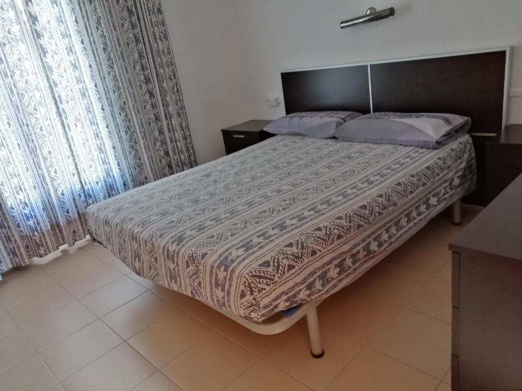 a bedroom with a large bed with a wooden headboard at Casa a 5 minutos playa Riells in L'Escala
