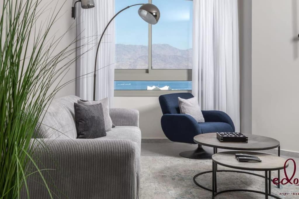 a living room with a couch and two chairs and a table at סוויטת View חדר שינה וסלון במתחם סי סייד in Eilat