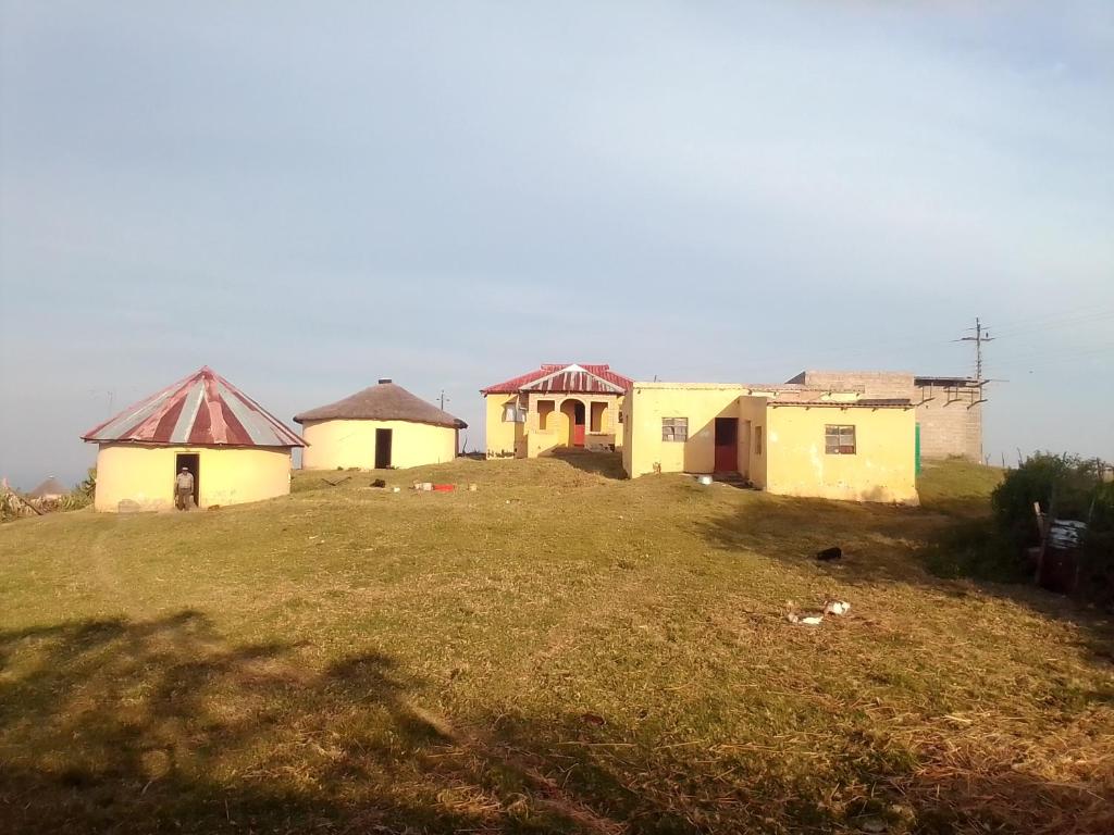 a group of houses on top of a hill at Tshezi Family in Ngqeleni