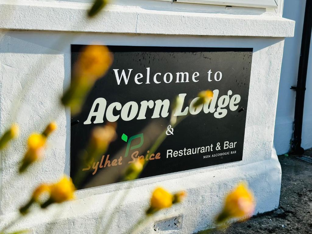a sign that says welcome to acorn ledge at Acorn Lodge Hotel Gatwick & Parking in Horley