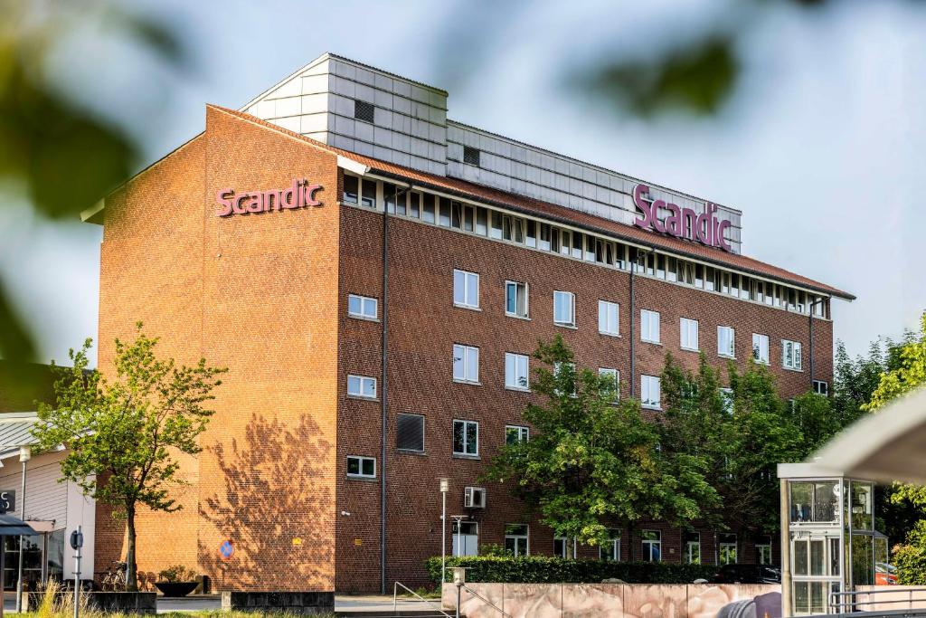 a large brick building with a santa cruz sign on it at Scandic Ringsted in Ringsted