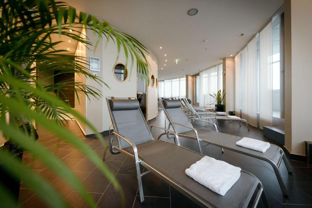 a row of chairs in a waiting room at Atlantic Hotel Sail City in Bremerhaven