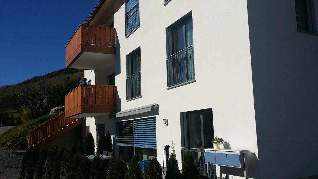 ein weißes Gebäude mit Balkon auf der Seite in der Unterkunft Chasa Scandella Apartment Tanja in Sent