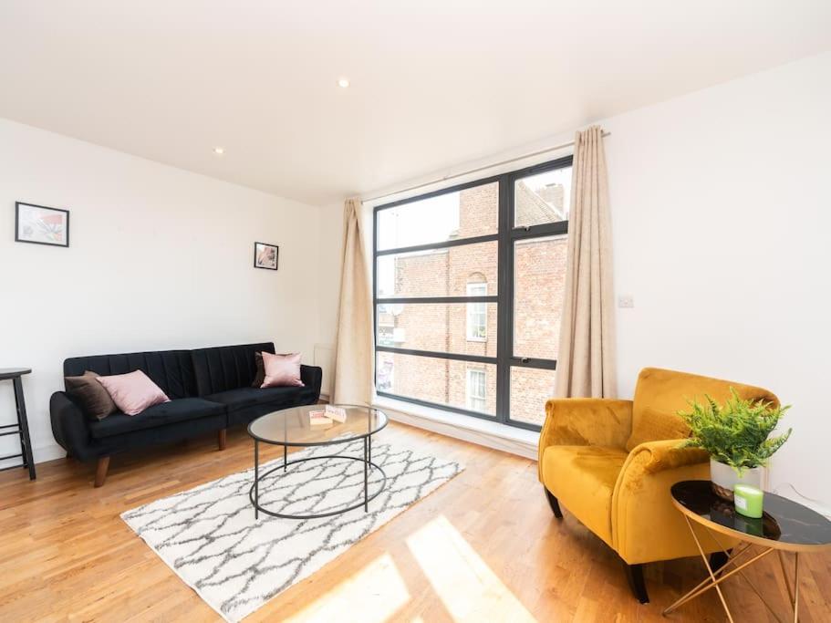 a living room with a couch and a table at Bright Modern 2 Bed Apartment in East London in London