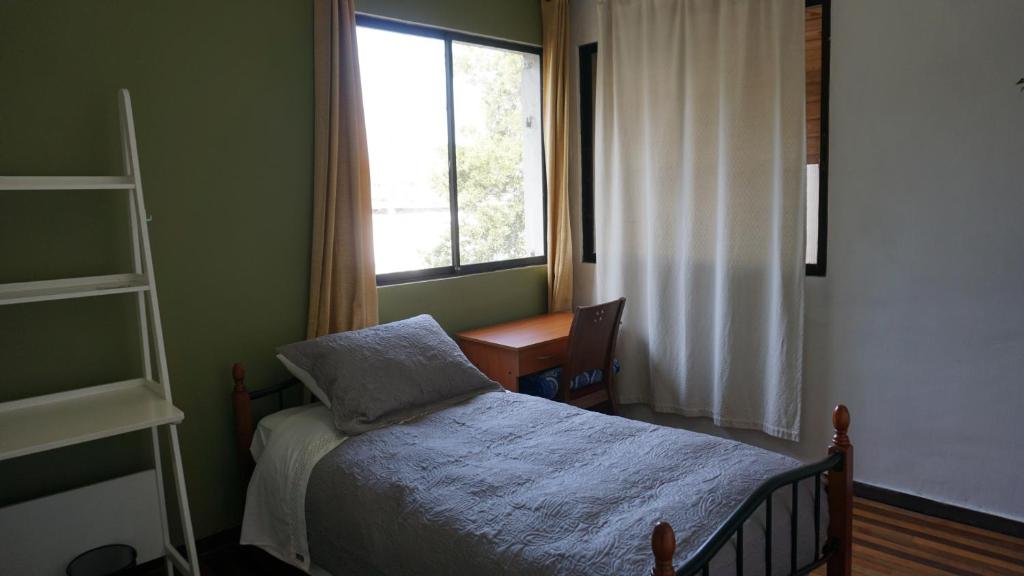 Voodi või voodid majutusasutuse Ventana Sur Hostal toas