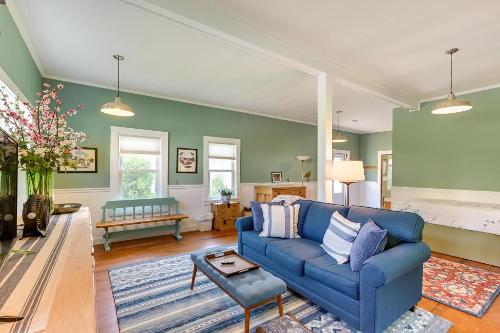 a blue couch in a living room with green walls at Pet-Friendly Maine Cottage By Northern Bay in Penobscot