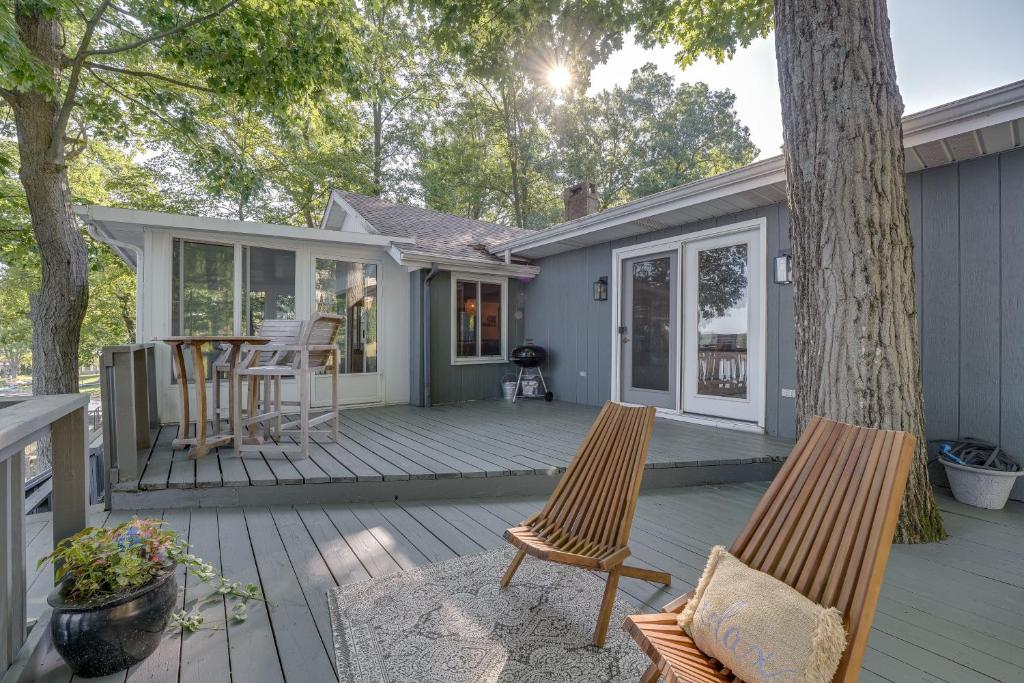 a deck with two chairs and a table on a house at Delton Oasis Retreat with Lake Views and Deck! in Delton