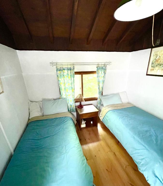 Postel nebo postele na pokoji v ubytování Gallery HARA and guest house