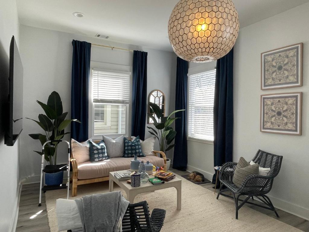 a living room with a couch and a table at New! Stylish 1900s Renovated Duplex Apartment Building Near Forsyth & River St in Savannah