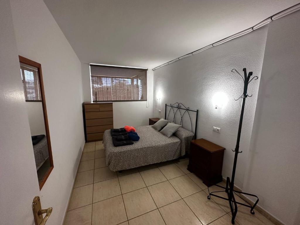 a bedroom with a bed and a lamp in a room at Vista Hermosa in Portals Nous