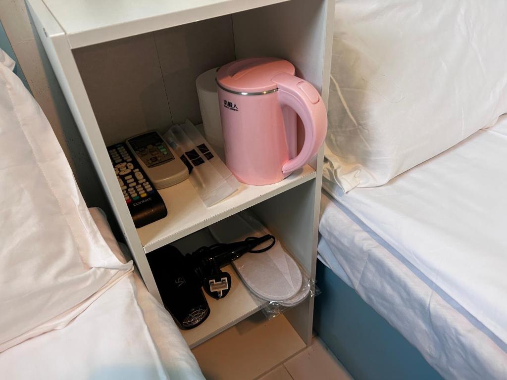 Postel nebo postele na pokoji v ubytování 香港名都商务旅馆 Ming Du Guesthouse