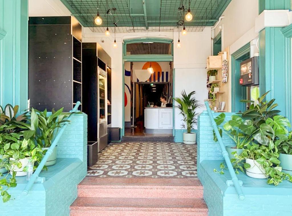 a hallway of a store with potted plants at Selina St Kilda Melbourne in Melbourne