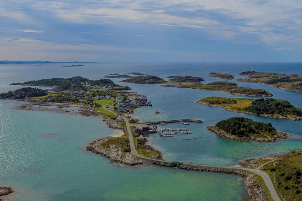 an aerial view of an island in the ocean at Koselig hus i det gamle fiskeværet Abelvær in Abelvær