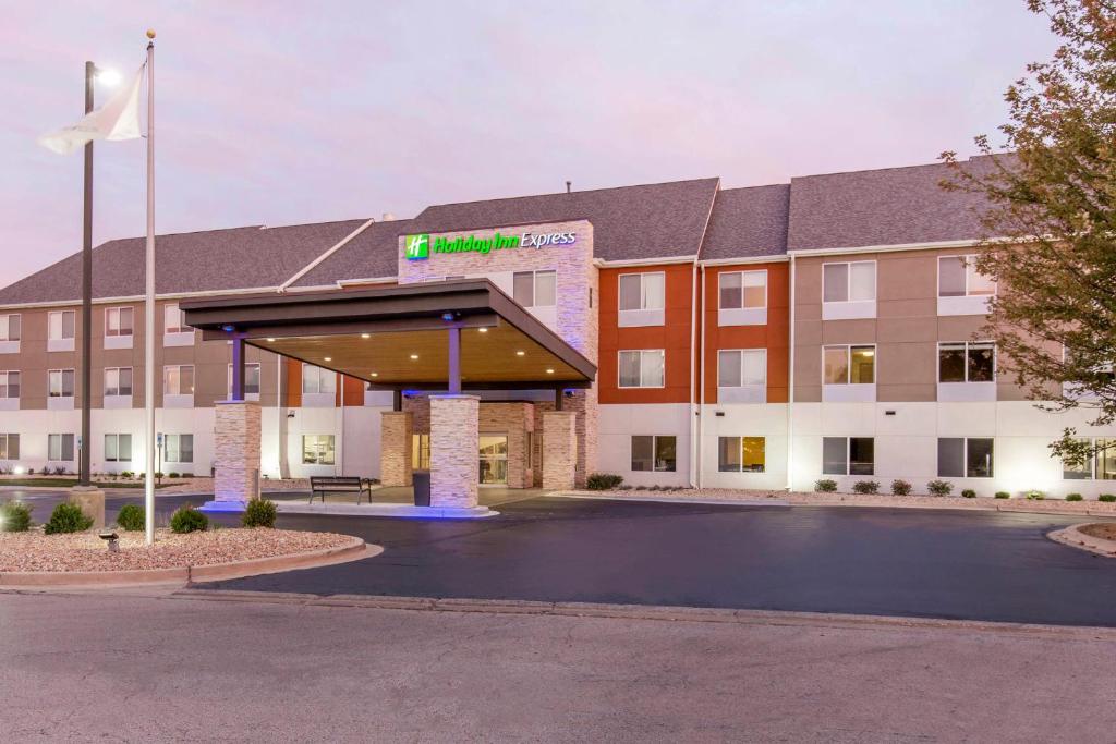 an exterior view of a hotel with a parking lot at Holiday Inn Express and Suites Chicago West - St Charles, an IHG Hotel in Saint Charles