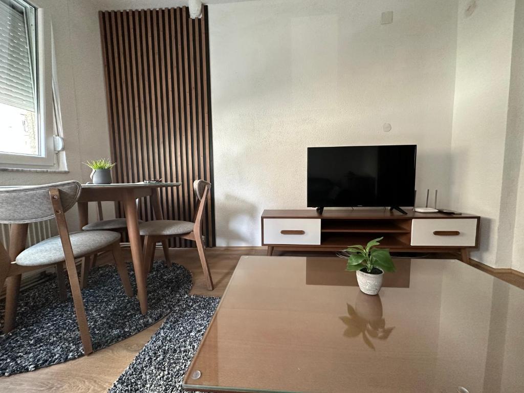un salon avec une télévision et une table dans l'établissement Central Apartment, à Strumica