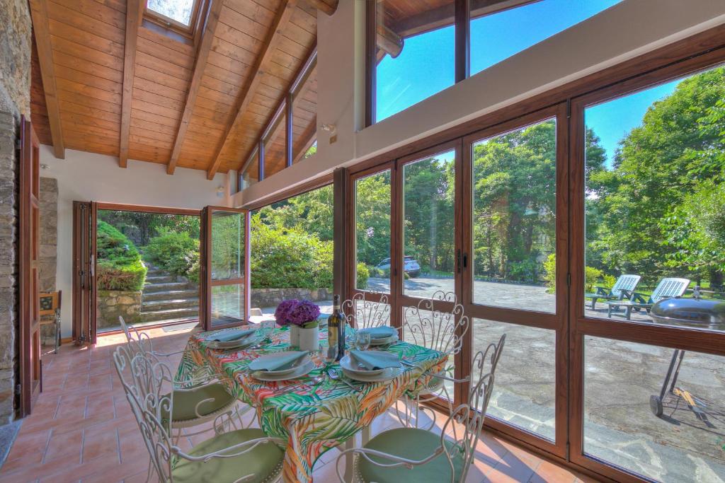 a dining room with a table and chairs at Villa Il Castagno Few Min From Beach - Happy Rentals in Castelveccana