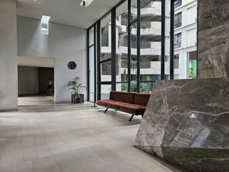 a lobby with a bench in a large building at Vintage GreyRoom - Family Stay in Dhaka