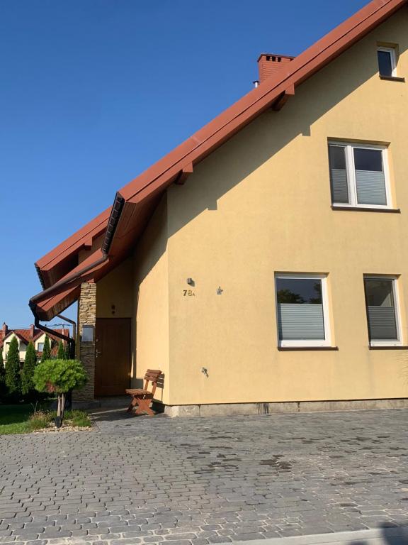 a house with a red roof and a brick driveway at Dunajec Home in Chełmiec