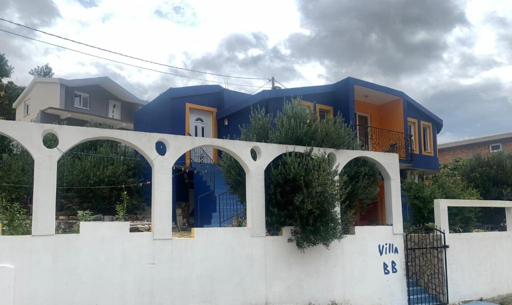 a blue house on top of a white fence at U Villi BB2 Gornji Zalik bb in Mostar