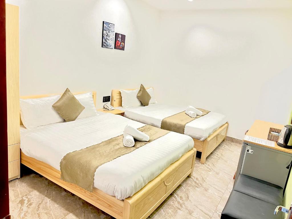 En eller flere senge i et værelse på Sunrise Valley Dalat Hotel