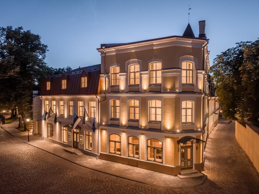 a large white building with lights on it at night at Nunne Boutique Hotel in Tallinn