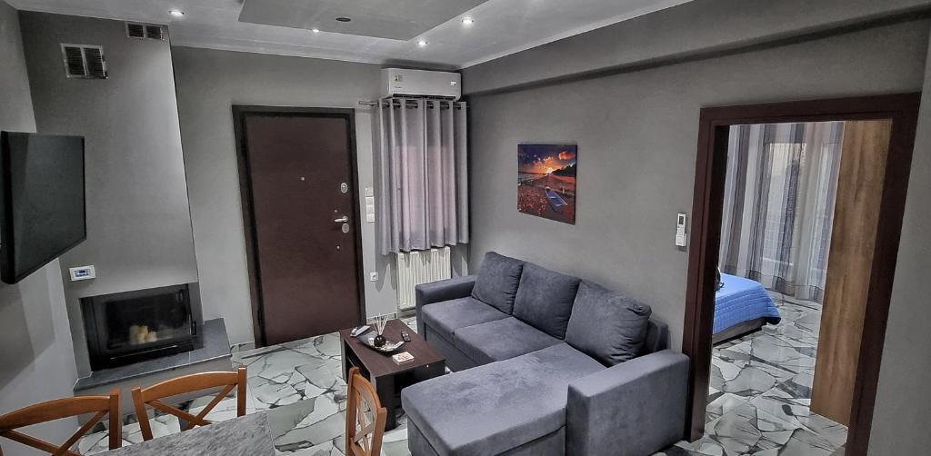 a living room with a couch and a tv at Mimarxos Luxury Apartments in Chalkida
