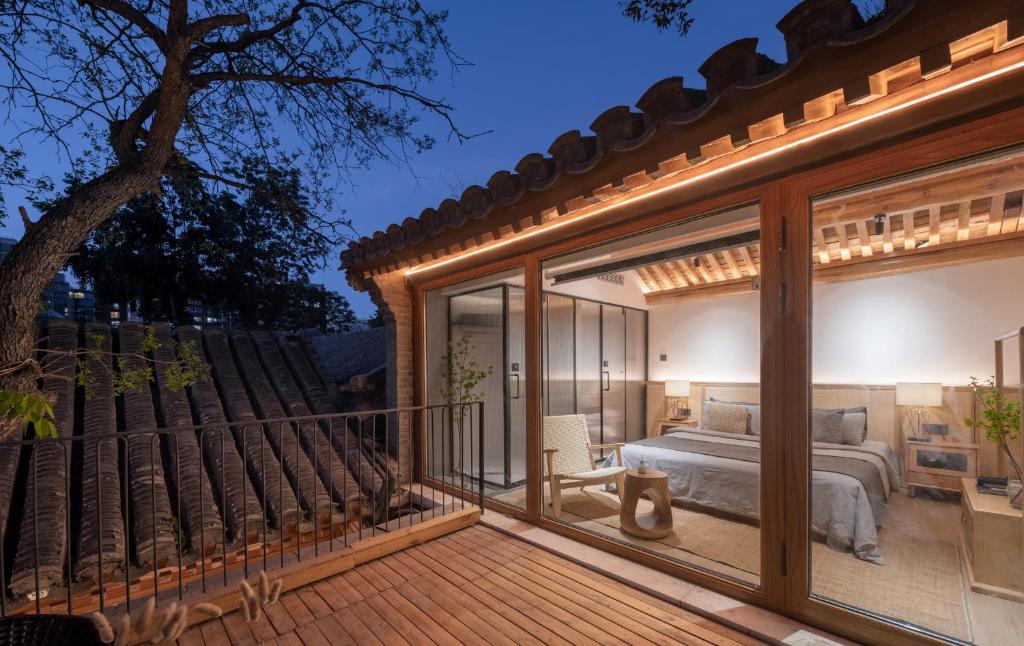 a room with a view of a bed and a balcony at Beijing wu tong in Beijing